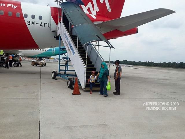 Hazeeq stepping out of the plane like a child star